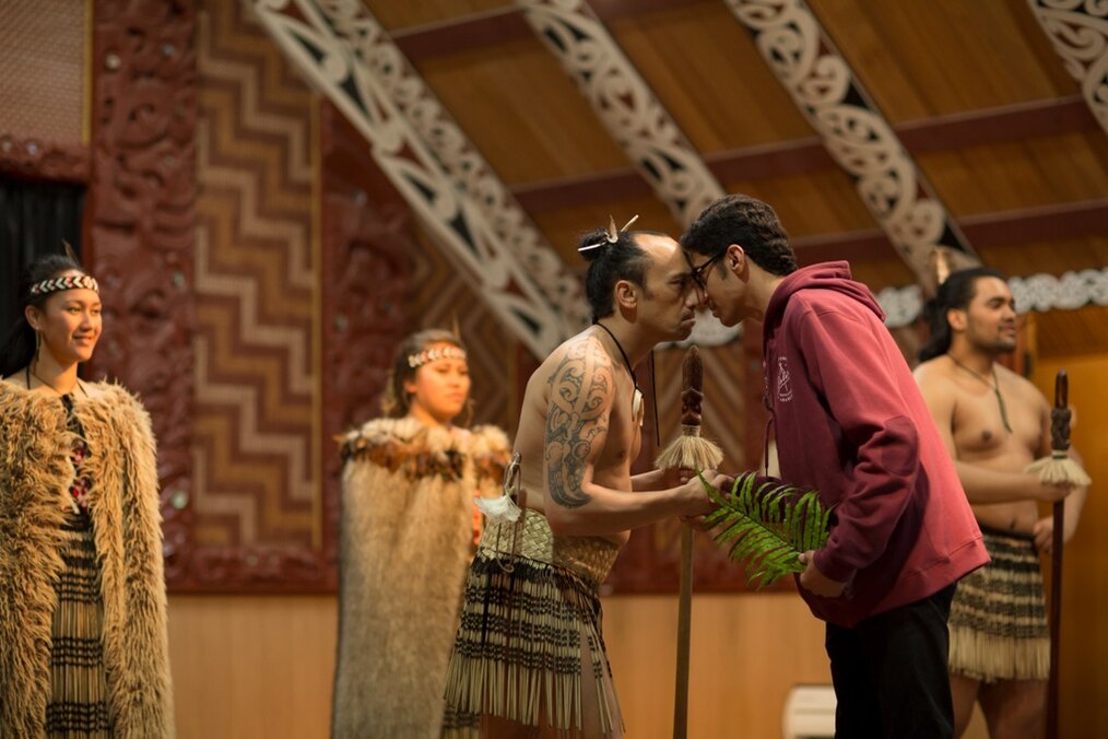 Credit: Education New Zealand Student in red hoodie doing a traditional Māori greeting with tribe member